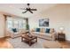 Bright living room with hardwood floors, comfortable seating, and large windows at 1486 E Augusta Ave, Chandler, AZ 85249