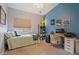 Bedroom with desk workspace and light teal walls at 1618 E Montoya Ln, Phoenix, AZ 85024