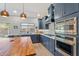 Modern kitchen with stainless steel appliances and butcher block island at 1618 E Montoya Ln, Phoenix, AZ 85024