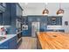 Modern kitchen with blue cabinetry and a large butcher block island at 1618 E Montoya Ln, Phoenix, AZ 85024