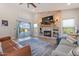 Living room with fireplace, sliding doors to backyard, and ample natural light at 1618 E Montoya Ln, Phoenix, AZ 85024