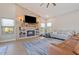 Spacious living room featuring a stone fireplace and large TV at 1618 E Montoya Ln, Phoenix, AZ 85024