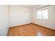 Bright bedroom featuring hardwood floors and a large window at 1636 E Juanita Ave, Mesa, AZ 85204