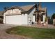 White stucco house with a two-car garage and desert landscaping at 1636 E Juanita Ave, Mesa, AZ 85204