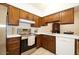 Galley kitchen with stainless steel appliances and wood cabinets at 1636 E Juanita Ave, Mesa, AZ 85204