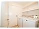 Laundry room with washer, dryer, and extra shelving at 1636 E Juanita Ave, Mesa, AZ 85204