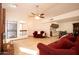 Bright living room with vaulted ceilings, red couches, and fireplace at 1636 E Juanita Ave, Mesa, AZ 85204