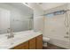 Clean bathroom with a tub, shower, and wood vanity at 17840 W Calavar Rd, Surprise, AZ 85388