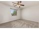 Bright bedroom with ceiling fan and window at 17840 W Calavar Rd, Surprise, AZ 85388