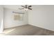 Bright bedroom with neutral walls and carpeting, and ceiling fan at 17840 W Calavar Rd, Surprise, AZ 85388