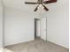 Bright bedroom with ceiling fan and access to hallway at 17840 W Calavar Rd, Surprise, AZ 85388