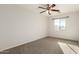 Spacious bedroom featuring a ceiling fan and ample natural light at 17840 W Calavar Rd, Surprise, AZ 85388