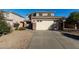 Two story house with attached garage and desert landscaping at 17840 W Calavar Rd, Surprise, AZ 85388