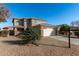 Two-story house with a neutral exterior, attached garage, and landscaping at 17840 W Calavar Rd, Surprise, AZ 85388