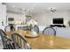 Dining area with wooden table and view into living room at 17855 W Thistle Landing Dr, Goodyear, AZ 85338