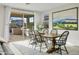 Bright dining room with wooden table and access to backyard at 17855 W Thistle Landing Dr, Goodyear, AZ 85338