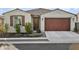 Single-story home with brown garage door and landscaping at 17855 W Thistle Landing Dr, Goodyear, AZ 85338