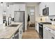 Modern kitchen with white cabinets and granite countertops at 17855 W Thistle Landing Dr, Goodyear, AZ 85338