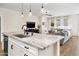 Modern kitchen island with a breakfast bar and sink at 17855 W Thistle Landing Dr, Goodyear, AZ 85338