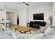 Living area with gray sectional and modern coffee table at 17855 W Thistle Landing Dr, Goodyear, AZ 85338