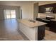 Open kitchen with island, granite countertops and stainless steel appliances at 18227 N Conquistador Dr, Maricopa, AZ 85138