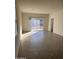 Bright living room with tile floors and sliding glass doors leading to backyard at 18227 N Conquistador Dr, Maricopa, AZ 85138