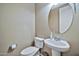 Powder room with pedestal sink and toilet at 18672 W Santa Irene Dr, Goodyear, AZ 85338