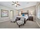 Main bedroom with ceiling fan and sitting area at 18672 W Santa Irene Dr, Goodyear, AZ 85338