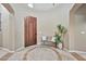 Bright entryway with a wooden door, tiled floor and a small bench at 18672 W Santa Irene Dr, Goodyear, AZ 85338