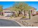 One-story house with desert landscaping, a large garage, and a stone facade at 18672 W Santa Irene Dr, Goodyear, AZ 85338