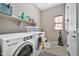 Laundry room with washer, dryer, and shelving at 18672 W Santa Irene Dr, Goodyear, AZ 85338