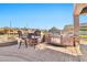 Outdoor kitchen with stainless steel appliances and bar seating at 18672 W Santa Irene Dr, Goodyear, AZ 85338