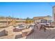 Outdoor kitchen and seating area with a fire pit at 18672 W Santa Irene Dr, Goodyear, AZ 85338