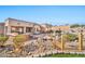 Outdoor patio area with a fire pit and a wooden bridge at 18672 W Santa Irene Dr, Goodyear, AZ 85338