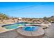 Inviting pool and spa with lounge chairs and string lights at 18672 W Santa Irene Dr, Goodyear, AZ 85338