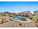 Relaxing backyard oasis with a pool, spa, and string lights at 18672 W Santa Irene Dr, Goodyear, AZ 85338