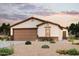 Single-story home with a 2-car garage and desert landscaping at 1885 Broken Arrow Dr, Wickenburg, AZ 85390