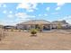 Home exterior view showcasing a large backyard with desert landscaping at 216 W Paoli St, San Tan Valley, AZ 85143