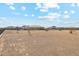 Large gravel backyard with a view of the house and surrounding landscape at 216 W Paoli St, San Tan Valley, AZ 85143