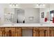 Bathroom with double vanity, wood cabinets, and large mirror at 216 W Paoli St, San Tan Valley, AZ 85143