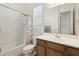 Bathroom with tub, shower, and wood vanity at 216 W Paoli St, San Tan Valley, AZ 85143