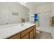 Bathroom with tub, shower, and wood vanity at 216 W Paoli St, San Tan Valley, AZ 85143