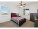 Guest bedroom with wood furniture, ceiling fan, and window at 216 W Paoli St, San Tan Valley, AZ 85143