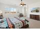 Main bedroom with large windows, ceiling fan, and wood furniture at 216 W Paoli St, San Tan Valley, AZ 85143