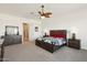 Bedroom with wood furniture, ceiling fan, and large window at 216 W Paoli St, San Tan Valley, AZ 85143