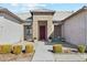 Inviting front entrance with a red door and well-manicured landscaping at 216 W Paoli St, San Tan Valley, AZ 85143