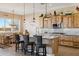 Kitchen with island, rustic wood cabinets, and granite countertops at 216 W Paoli St, San Tan Valley, AZ 85143