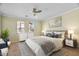 Comfortable bedroom with neutral tones, ceiling fan, and large windows providing ample natural light at 21809 N 39Th St, Phoenix, AZ 85050
