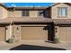 Two-car garage with tan doors and brick facade at 21809 N 39Th St, Phoenix, AZ 85050