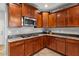 Corner view of kitchen with gas cooktop and wood cabinets at 21809 N 39Th St, Phoenix, AZ 85050